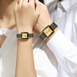Elegant rectangular couple watches featuring gold and black ceramic straps on couple's wrists