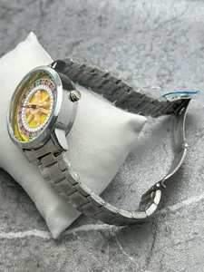 Close-up of men's creative roulette spinning dial watch with silver stainless steel strap.