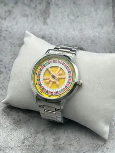 Macro detail of rotating roulette wheel dial on silver metal men's wristwatch model
