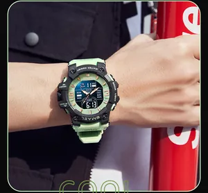 Close-up of SMAEL men's sports watch with dual display and green strap on wrist