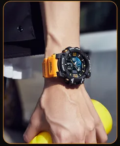 Close-up of SMAEL men's sport waterproof digital watch on a wrist with orange strap