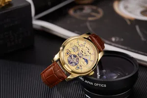 Close-up of golden skeletal tourbillon watch with brown leather strap and intricate dial
