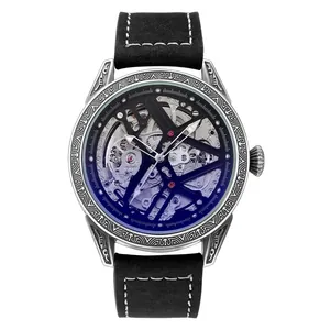 Vue détaillée d'une montre squelette automatique pour homme avec un boîtier argenté gravé.