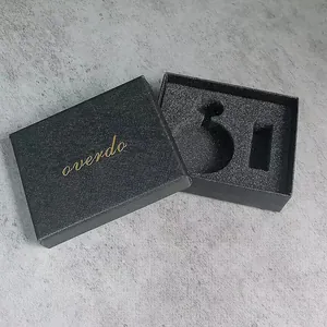 Close-up detail of black cross-grain textured watch gift box featuring elegant gold logo
