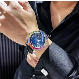 Detail of men's mechanical watch with starry sky dial and rainbow bezel on wrist