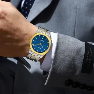 Close-up view of BESTWIN men's quartz watch with blue dial and two-tone steel strap
