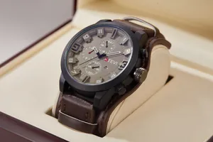 Detailed close-up of K TEVI oversized military style men's sports watch with brown leather strap