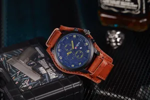 Macro view of KTEVI men's oversized sports watch with brown leather cuff strap.