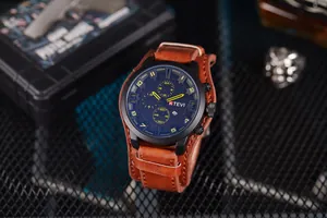 Detailed view of military-style men's chronograph watch with brown leather strap