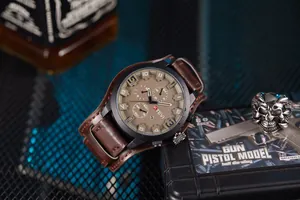 Close-up of KTEVI men's large dial watch with brown leather strap and tactical sub-dials.
