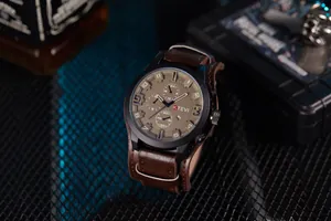 Close-up of tactical men's sport watch with brown leather strap and multi-dial display