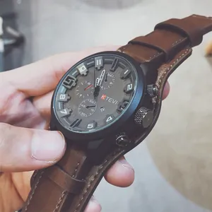 Detailed view of KTEVI men's oversized sports watch with brown leather strap and black dial