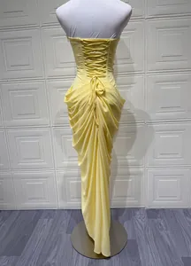 Detailed back view of yellow strapless gown with corset lace-up and elegant draping