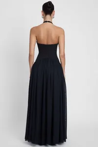 Back view of elegant black halter neck backless evening gown with pleated maxi skirt