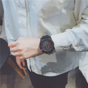 Close-up of a stylish black oversized sports watch with red markers on a wrist