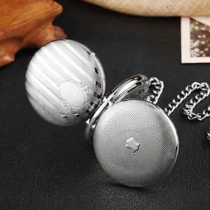 Macro detail of vintage silver mechanical pocket watch with double-sided striped texture