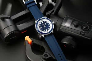Close-up of AOCASDIY blue silicone strap sports watch with professional photo gear