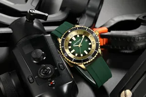 Detailed close-up of AOCASDIY men's fashion watch featuring a green dial and gold-tone bezel