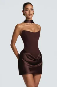 Close-up of a dark brown strapless corset dress featuring a pleated satin mini skirt.