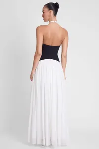 Elegant French style backless evening gown with black bodice and white pleated skirt.