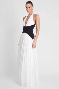 Detailed view of the black contrast waist belt on a white French halter neck gown