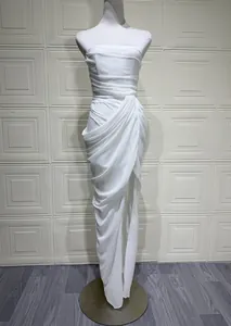 Full detail of elegant white strapless ruched maxi dress featuring a high side slit