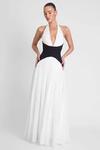 Elegant white and black halter neck maxi dress with deep V-neck and cinched waist.