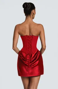 Rear view of sexy red satin mini dress featuring a corset lace-up back and draped skirt