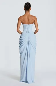 Detail showing the back of a light blue strapless gown with corset lacing and draped pleating