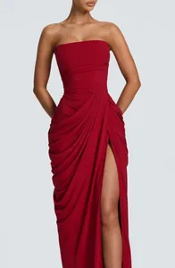 Elegant red strapless maxi dress with pleated draping and a sexy high leg slit detail.