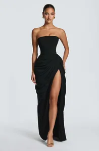 Detailed view of an elegant black strapless floor-length gown with a thigh-high slit