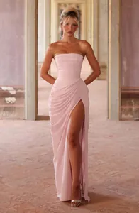 Front view of an elegant pink strapless gown featuring ruched pleats and a high slit