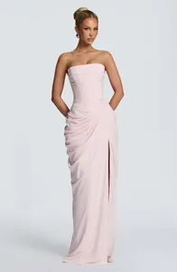 Elegant pink strapless evening gown with pleated bodice and thigh-high slit detail
