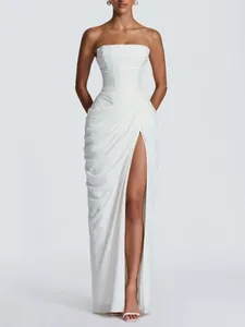 Elegant strapless pleated white evening gown with high slit and slim fit.
