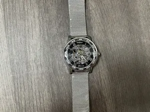 Detailed close-up of Winner silver skeleton mechanical watch with mesh strap and rhinestone bezel