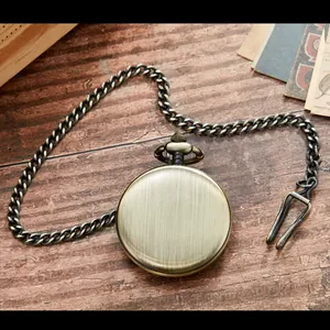 Klassische runde Taschenuhr aus Bronze mit Kette auf rustikalem Holzhintergrund