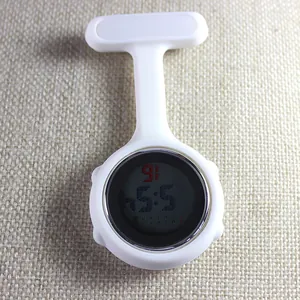 Detail view of white silicone digital nurse fob watch on textured background