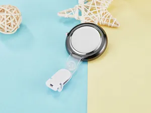 Rear view detail of a sleek black quartz nurse watch with white clip attachment