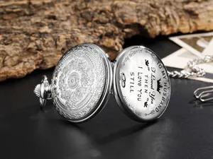 Vue détaillée d'une montre à gousset argentée gravée avec message romantique pour mari