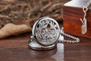 Vue rapprochée d'une montre à gousset vintage avec gravure de dragon et phénix.