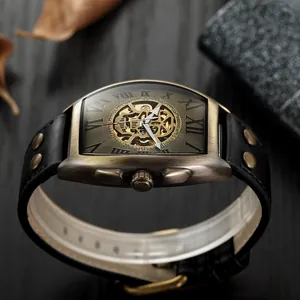 Side view of vintage bronze mechanical skeleton watch with black rivet leather strap