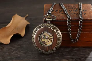 Detail of vintage mechanical pocket watch featuring skeleton movement and wood grain finish