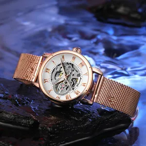 Detailed view of Forsining rose gold skeleton mechanical watch on wet rock surface