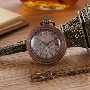 Close-up of a vintage wooden quartz pocket watch with bronze chain on a wooden desk