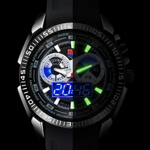 Detail showing luminous green hands and markers on a TVG dual-display sports watch