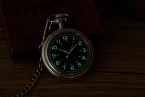 Vue détaillée d'une montre à gousset rétro avec chiffres verts lumineux dans le noir