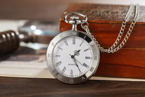 Vintage silver pocket watch with Roman numerals and quartz movement on a wooden box