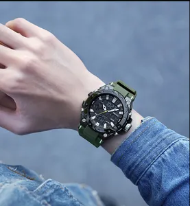 Detailed macro view of SMAEL men's military sport watch with green strap on a wrist