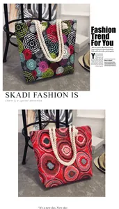 Detail showing ethnic floral and red patterns on canvas totes with rope handles.