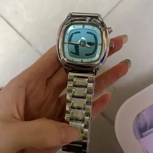 Close-up of a men's vintage-style quartz watch with a light blue dial and metal link strap